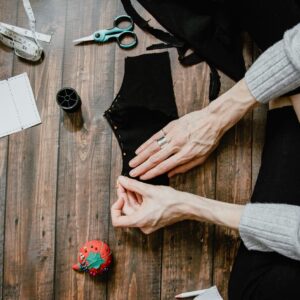 person in black long sleeve shirt holding red round ornament